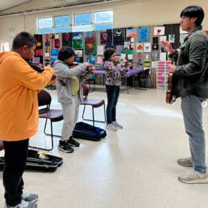 Rafael Vazquez with group of violin students