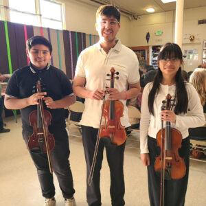 Rafael Vazquez with violin students posing